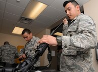 Airman First Class Eduardo Granados, 2nd Security Forces Squadron installation entry controller, cleans the barrel of an M4 carbine at Barksdale Air Force Base, La., April 1. When cleaning the weapon, the barrel must be inspected for anything that might block the path of a bullet. (U.S. Air Force photo/Senior Airman Amanda Morris)