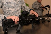Airman First Class Miguel Pichardo, 2nd Security Forces Squadron gate guard, inspects M4 carbine after finishing a routine cleaning at Barksdale Air Force Base, La., April 1. After reassembly, performing an inspection and function check is important to ensure everything is in proper working condition. (U.S. Air Force photo/Senior Airman Amanda Morris) 