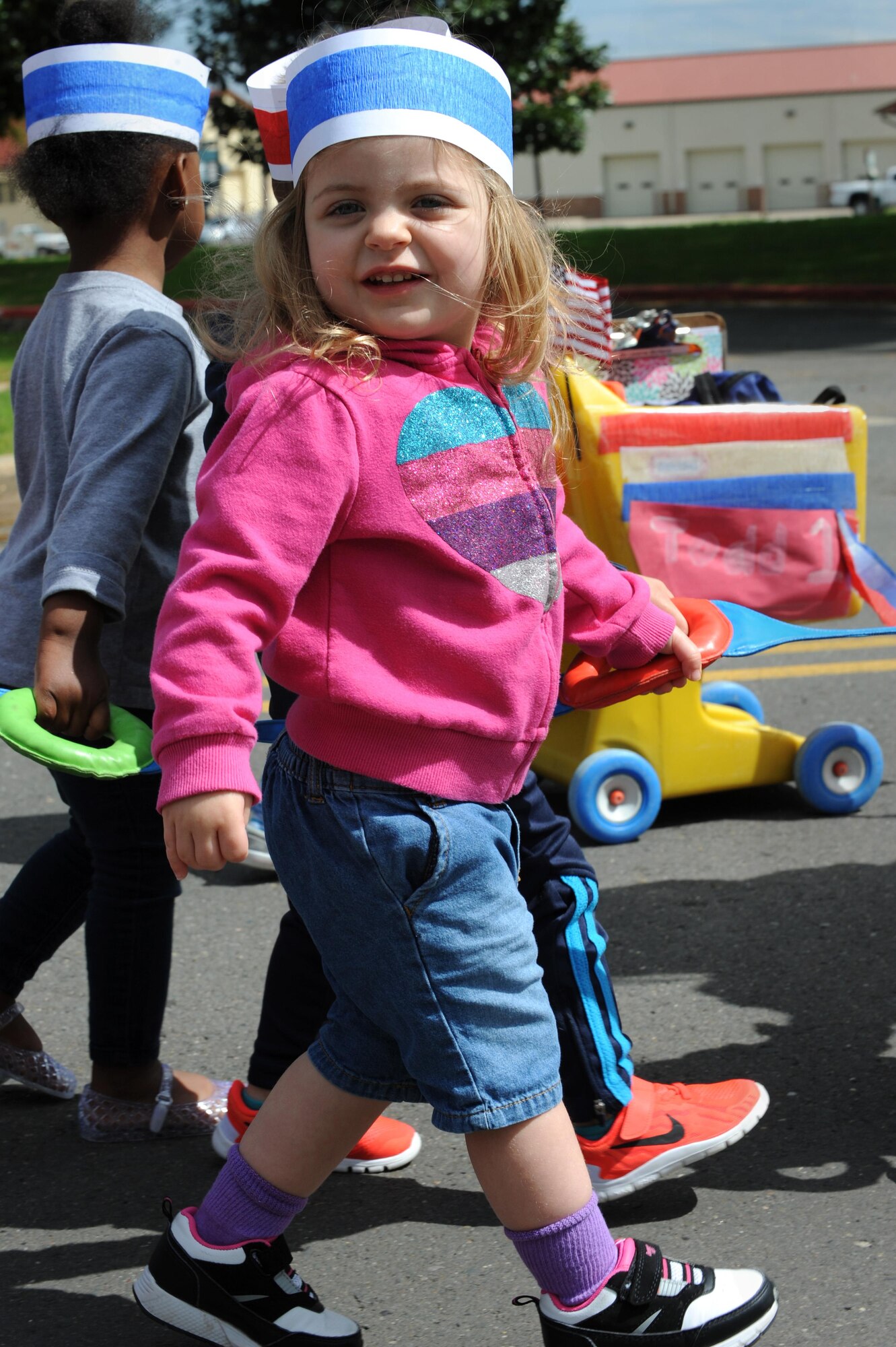 Children, parents and Child Development Center child care providers participate in the Month of the Military Child Parade at Barksdale Air Force Base, La., April 1. The parade was held to support the Month of the Military Child in observance of the contribution families make to mission readiness. (U.S. Air Force photo/Airman Alexis C. Frost)