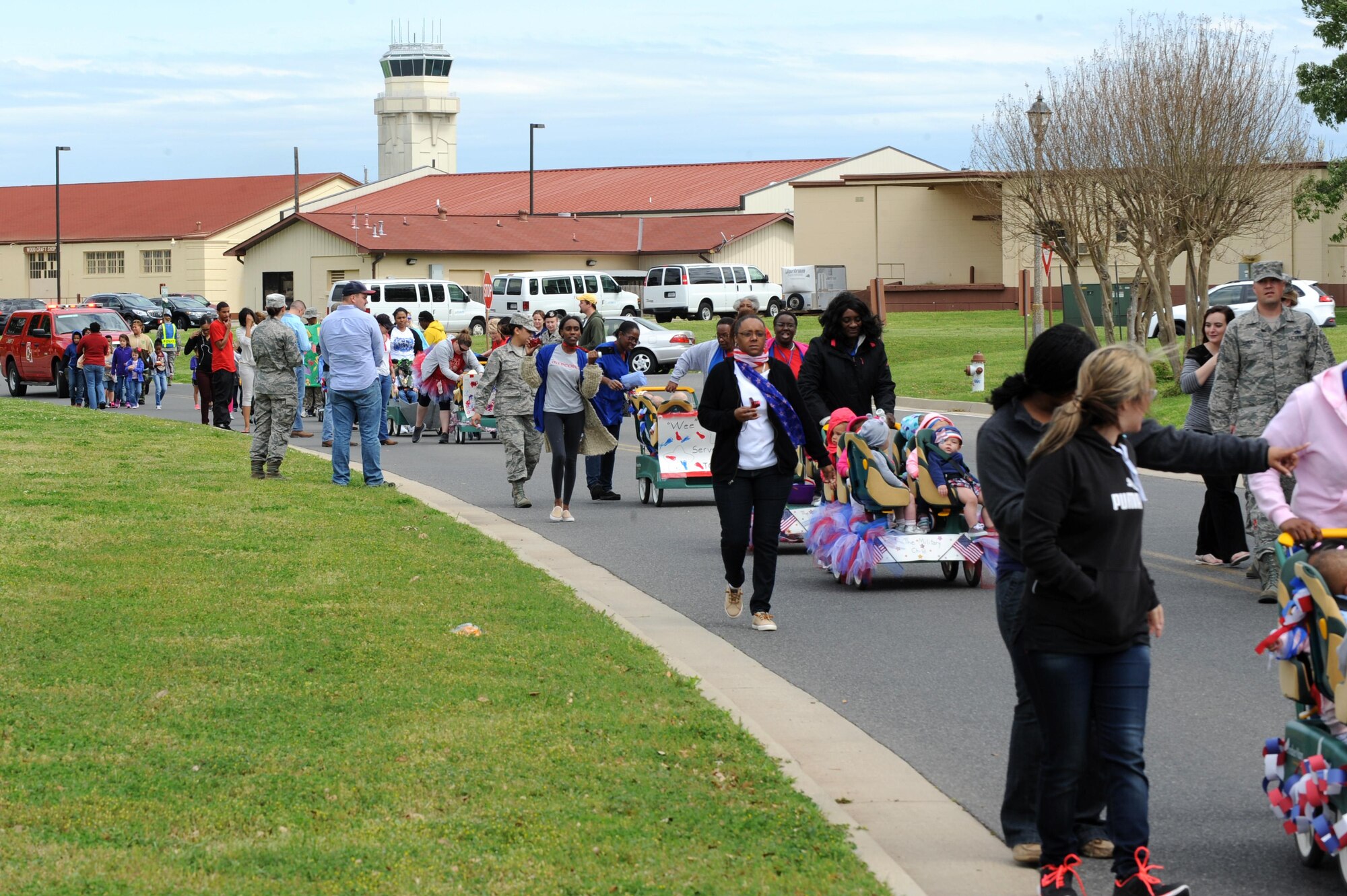 Children, parents and Child Development Center child care providers participate in the Month of the Military Child parade at Barksdale Air Force Base, La., April 1. April is recognized as Month of the Military Child and Child Abuse Prevention Month throughout the military. (U.S. Air Force photo/Airman Alexis C. Frost)