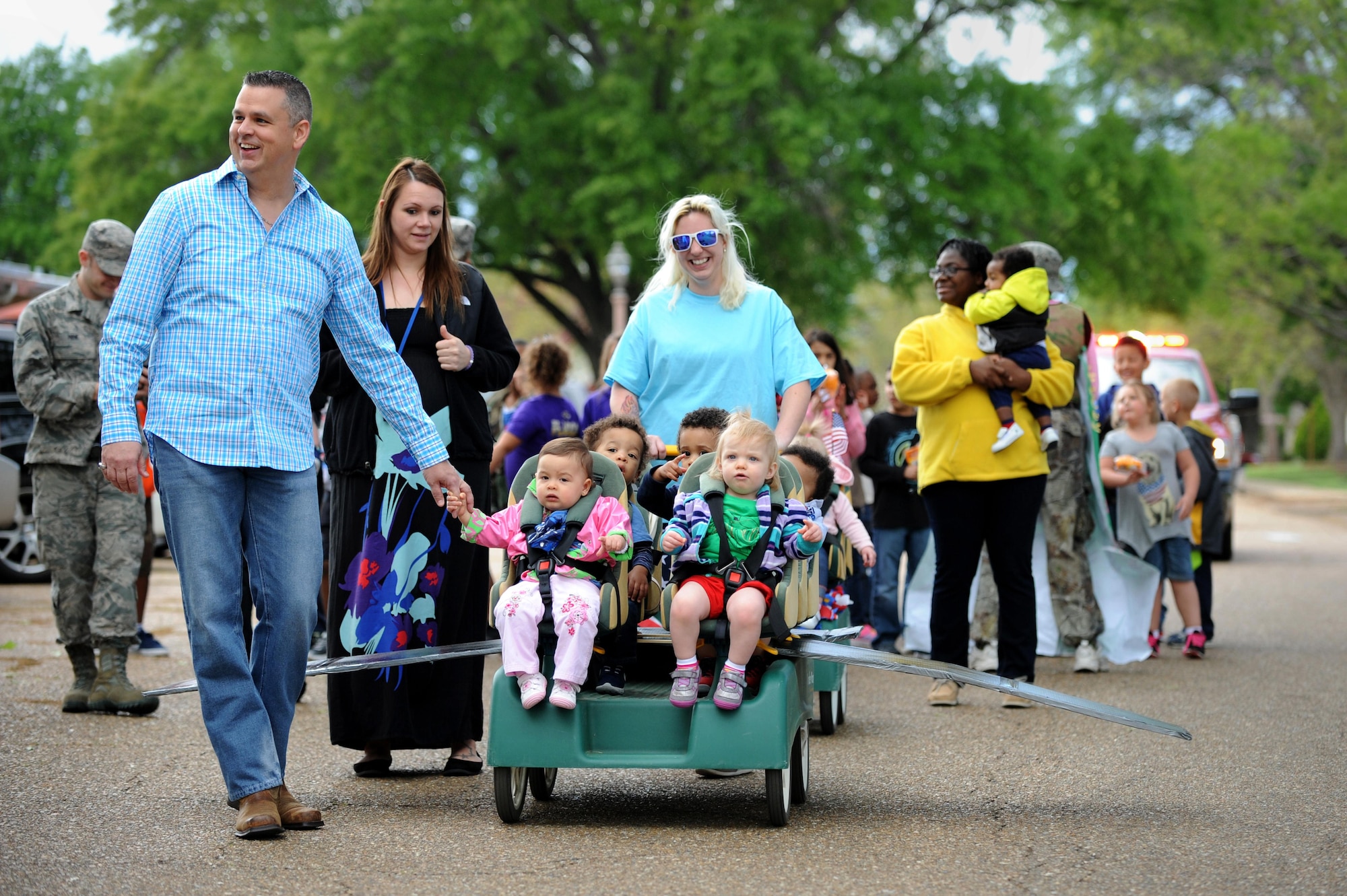 Parents and their children participate in a parade outside the Child Development Center at Barksdale Air Force Base, La., April 1. The parade was held to support the Month of the Military Child and reinforce the important role parents play in maintaining Air Force intergrity, service before self, and excellence in all we do. (U.S. Air Force photo/Airman Alexis C. Frost)