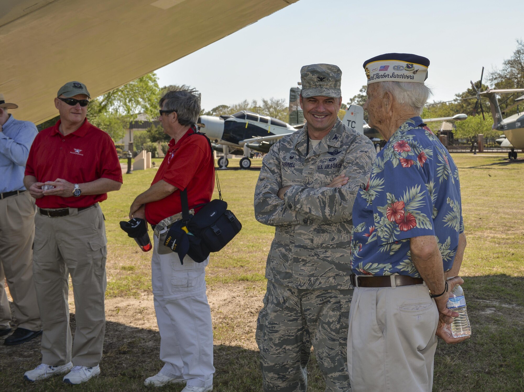 U.S. Air Force Col. Sean Farrell, left, commander of the 1st Special Operations Wing, and U.S. Marine retired Sgt. Maj. Bill Braddock, Pearl Harbor survivor, talk during a tour at Hurlburt Field, Fla., April 5, 2016. During the tour, Braddock and three fellow Pearl Harbor survivors spent time with Air Commandos to discuss their experiences and the differences they see in today’s force. (U.S. Air Force photo by 2nd Lt. Jaclyn Pienkowski)