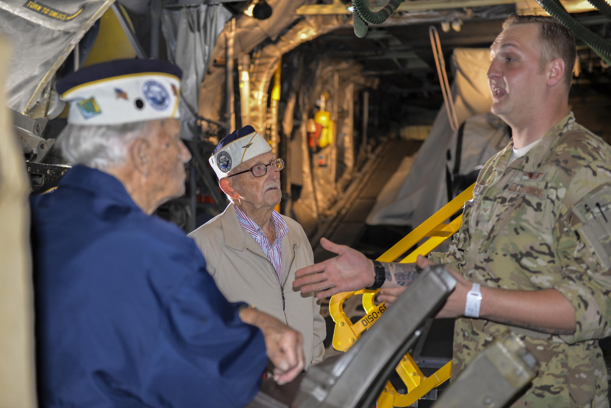 U.S. Air Force Senior Airman Jake Peters, a special missions aviator sensor operator with the 4th Special Operations Squadron, speaks with retired U.S. Marine Sgt. Maj. Bill Braddock, left, and retired U.S. Navy Lt. Cmdr. Cass Phillips, middle, Pearl Harbor survivors, during a tour of an AC-130U Spooky Gunship at Hurlburt Field, Fla., April 5, 2016. During a base tour, Braddock, Phillips and two fellow Pearl Harbor survivors spent time with Air Commandos to discuss their experiences and the differences they see in today’s force. (U.S. Air Force photo by 2nd Lt. Jaclyn Pienkowski)