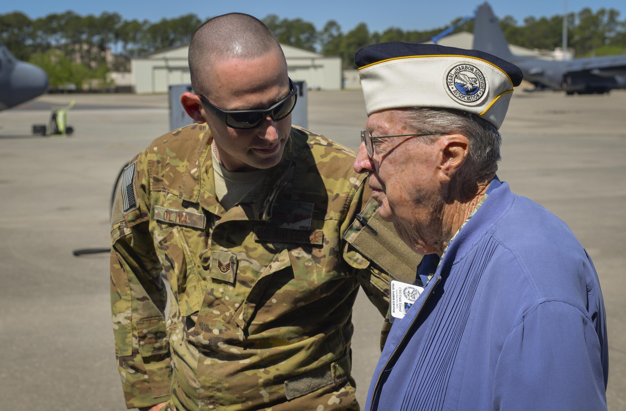 U.S. Air Force Staff Sgt. Anthony Oliva, a special missions aviator sensor operator with the 4th Special Operations Squadron, talks to retired U.S. Navy Chief Warrant Officer 4 Francis Edmond, a Pearl Harbor survivor, at Hurlburt Field, Fla., April 5, 2016. During a base tour, Edmond and three fellow Pearl Harbor survivors spent time with Air Commandos to discuss their experiences and the differences they see in today’s force. (U.S. Air Force photo by 2nd Lt. Jaclyn Pienkowski)