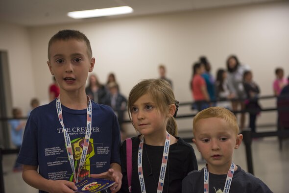 Three children stand in a mock deployment line at Gunfighter Jr. April 4, 2016 at Mountain Home Air Force Base, Idaho. During Gunfighter Jr. kids learn firsthand what it's like when a parent deploys. (U.S. Air Force photo by Airman Alaysia Berry/Released)