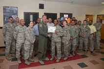 Staff Sgt. Tynesha Sweeney, center, 47th Security Forces Squadron NCO in charge of standardizations and evaluations, accepts the “XLer of the Week” award from Col. Thomas Shank, left, 47th Flying Training Wing commander, and Chief Master Sgt. Teresa Clapper, right, 47th FTW command chief, here, March 30, 2016. The XLer is a weekly award chosen by wing leadership and is presented to those who consistently make outstanding contributions to their unit and Laughlin. (U.S. Air Force photo by Airman 1st Class Brandon May)