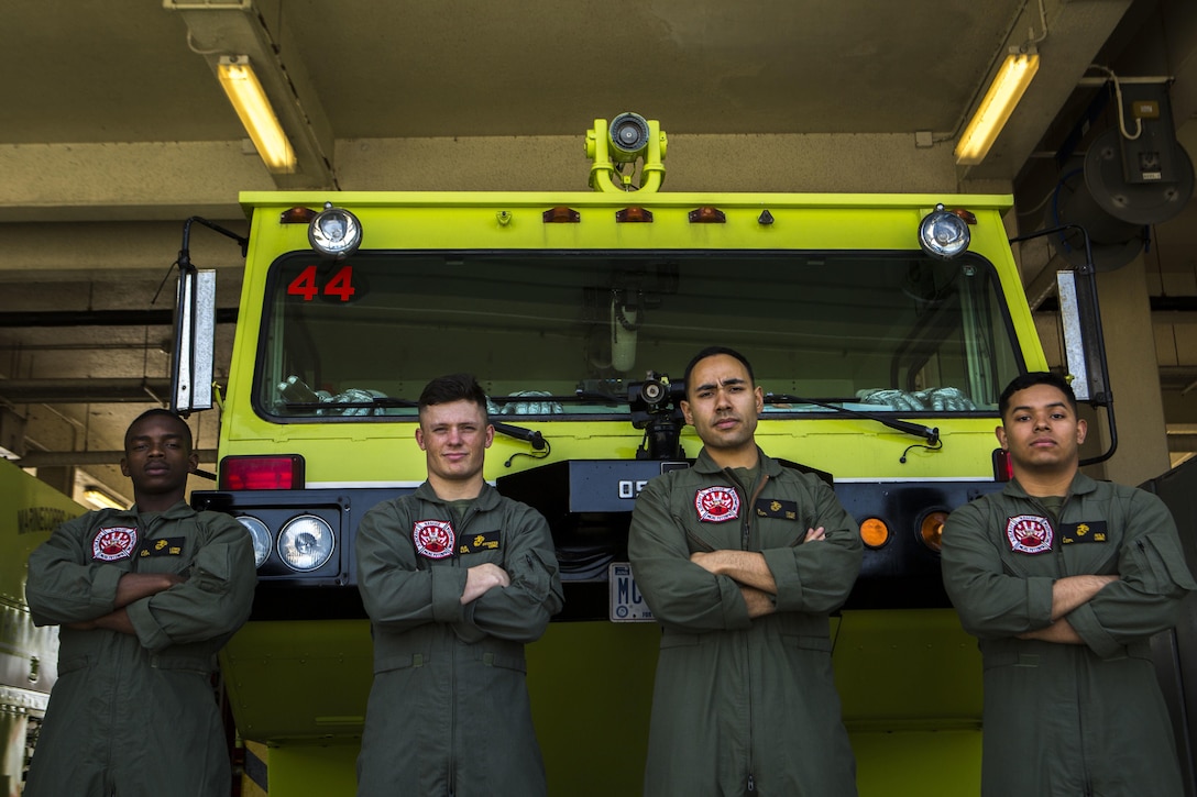 Lance Cpl. Jeremie Lewis, Lance Cpl. Quinn Beckens, Lance Cpl. Rodrigo Cruzvera, and Lance Cpl. Javier Avila Jr. stand in front on their fire truck April 1, 2016. The Marines are aircraft rescue and firefighting Marines with Headquarters and Headquarters Squadron, Marine Corps Air Station Futenma, Marine Corps Installations Pacific. Lewis is from South Haven, Miss.; Beckens is from Sodus, N.Y.; Crusvera is from Gardnerville, Nev.; Avila is from San Augustine, Texas. (U.S. Marine Corps photo by Lance Cpl. Kelsey M. Dornfeld/ Released)