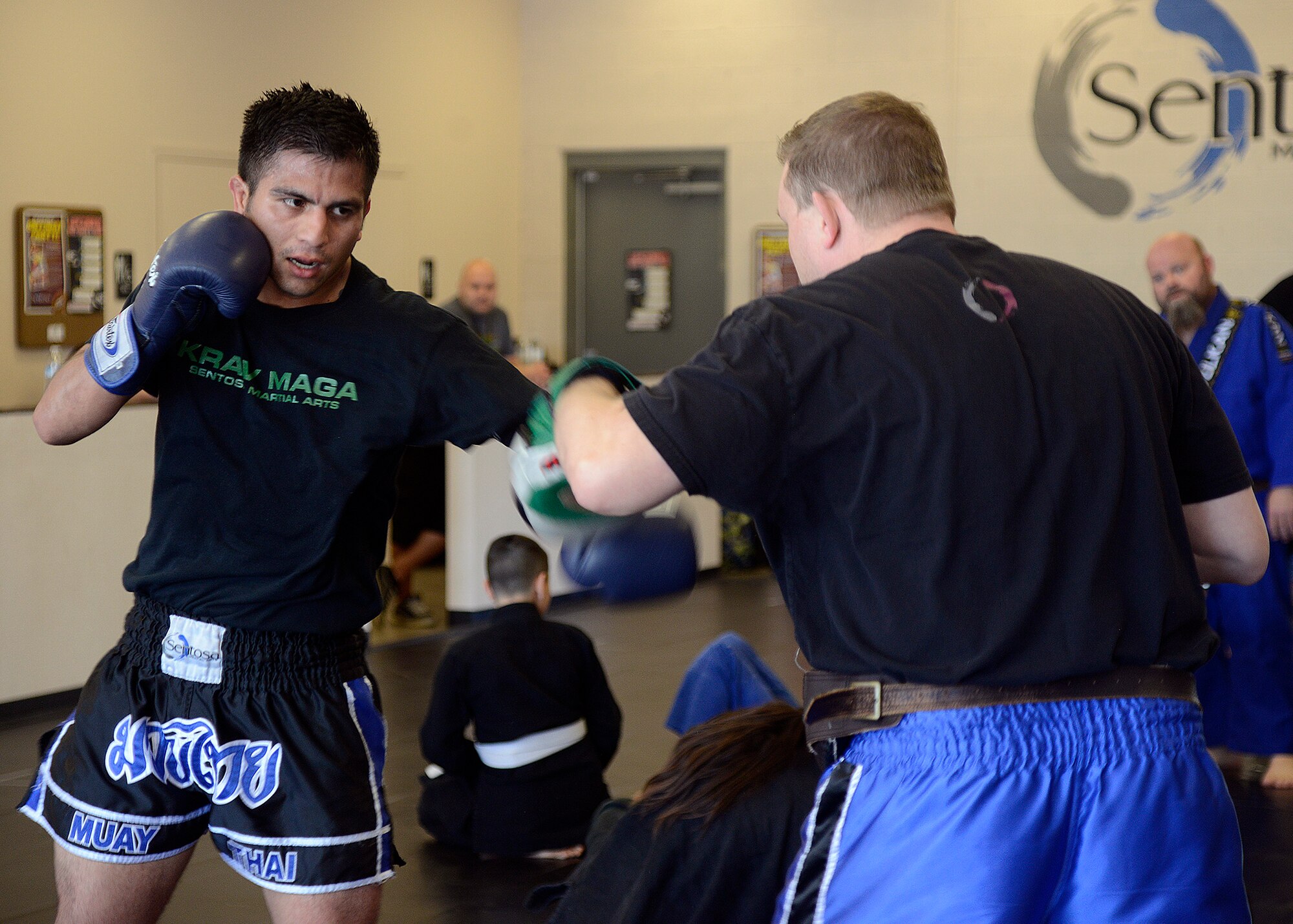 Senior Airman Adrian Cook, 56th Security Forces Squadron patrolman, spars with an instructor during his black belt ceremony at Sentosa Martial Arts in Avondale, Ariz., March 12, 2016. In order to receive the black belt, Cook had to go through rigorous training which included boxing, sparring, and ground game (U.S. Air Force photo by Senior Airman Devante Williams)
