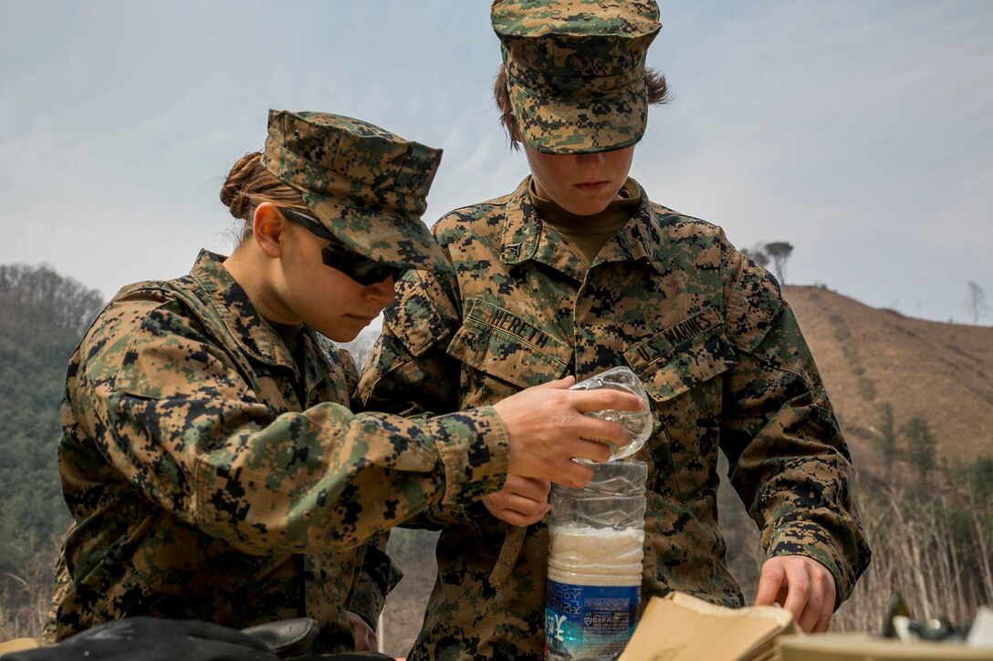 U.S. Marine Cpl. April Flores, left, and Lance Cpl. Anna Hereth build an improvised shape charge for a demolition range as a part of Korean Marine Exchange Program 16-16 on Camp Rodriguez, South Korea, March 30, 2016. KMEP is an exercise designed to allow ROK Marines and U.S. Marines to work together side-by-side as a cohesive unit and help strengthen the relationship between the two nations. The ROK Marines are with 1st ROK Marine Division. Flores, from Fort Worth, Texas, and Hereth, from Kansas City, Missouri, are food service specialists attached to 9th Engineer Support Battalion, 3rd Marine Logistics Group, III Marine Expeditionary Force. (U.S. Marine Corps photo by Cpl. Ryan C. Mains/ Released)