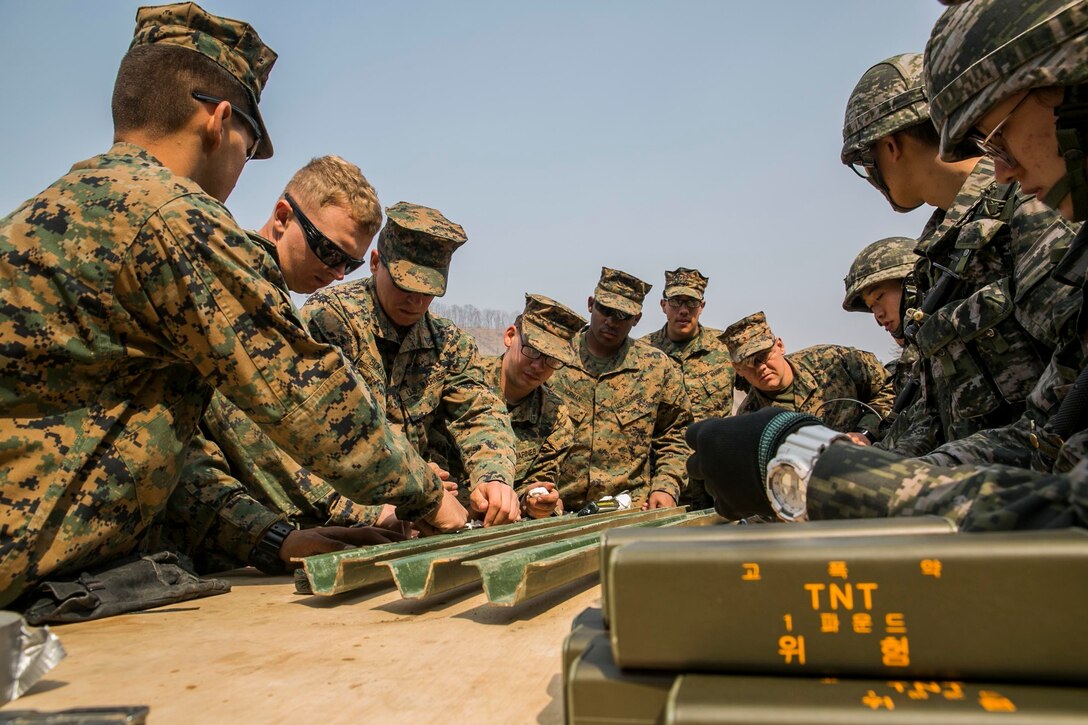 Republic of Korea Marines and U.S. Marines build improvised bangalore charges for a demolition range as a part of Korean Marine Exchange Program 16-16 on Camp Rodriguez, South Korea, March 30, 2016. KMEP is an exercise designed to allow ROK Marines and U.S. Marines to work together side-by-side as a cohesive unit and help strengthen the relationship between the two nations. The ROK Marines are with 1st ROK Marine Division. The U.S. Marines are with 9th Engineer Support Battalion, 3rd Marine Logistics Group, III Marine Expeditionary Force. (U.S. Marine Corps photo by Cpl. Ryan C. Mains/ Released)