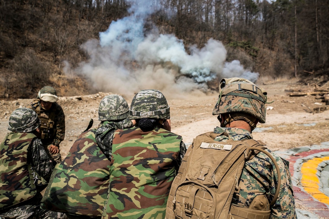 Republic of Korea Marines and U.S. Marine Sgt. Kenneth Benson watch an explosion during a demolition range as a part of Korean Marine Exchange Program 16-16 on Camp Rodriguez, South Korea, March 30, 2016. KMEP is an exercise designed to allow ROK Marines and U.S. Marines to work together side-by-side as a cohesive unit and help strengthen the relationship between the two nations. The ROK Marines are with 1st ROK Marine Division. Benson, from St. Petersburg, Florida, is a combat engineer with 9th Engineer Support Battalion, 3rd Marine Logistics Group, III Marine Expeditionary Force. (U.S. Marine Corps photo by Cpl. Ryan C. Mains/ Released)