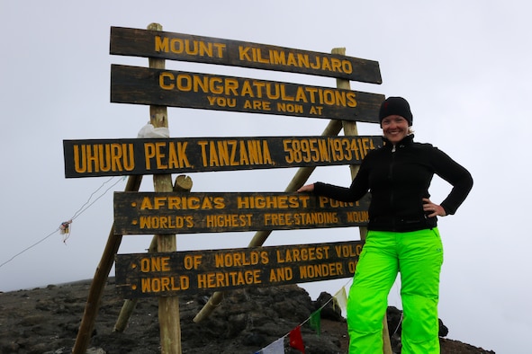 Leia Johnson stands at the Uhuru Peak on Mount Kilamanjaro, which is the highest on the mountain, March 8, 2016 in Tanzania, Africa. Uhuru Peak is the highest summit of Mount Kilamanjaro. (Courtesy photo by Chelsea Hudson Photography)