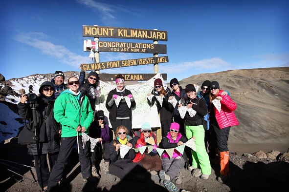 A group of 15 women and one man pose together at the first summit they reached on their trip of climbing Mount Kilamanjaro, in March, 2016, in Tanzania, Africa. The group climbed Mount Kilamanjaro to raise money and awareness for women who live in warzones. (Courtesy photo by Chelsea Hudson Photography)