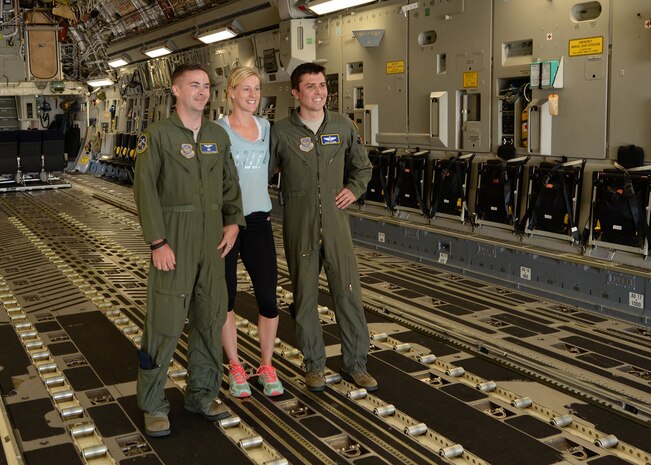 Staff Sgt. David McCubbin, 14th Airlift Squadron loadmaster, and Capt. David Schunk, 14th AS pilot, meet with Alison Riske, professional tennis player April 5, 2016, on a C-17 Globemaster III at JB Charleston – Air Base, S.C. Riske is in Charleston competing in the Family Circle Cup tennis tournament and visited the Air Base to sign autographs for Team Charleston members and tour a C-17 Globemaster III. (U.S. Navy photo/Mass Communications Specialist 1st Class Sean Stafford)