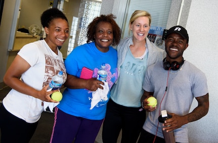 Alison Riske, professional tennis player, hands out autographed tennis balls to Joint Base Charleston members April 5, 2016, at the fitness center on JB Charleston – Air Base, S.C. Riske is in Charleston competing in the Family Circle Cup tennis tournament and visited the Air Base to sign autographs for Team Charleston members and tour a C-17 Globemaster III. (U.S. Air Force photo/Senior Airman Clayton Cupit)