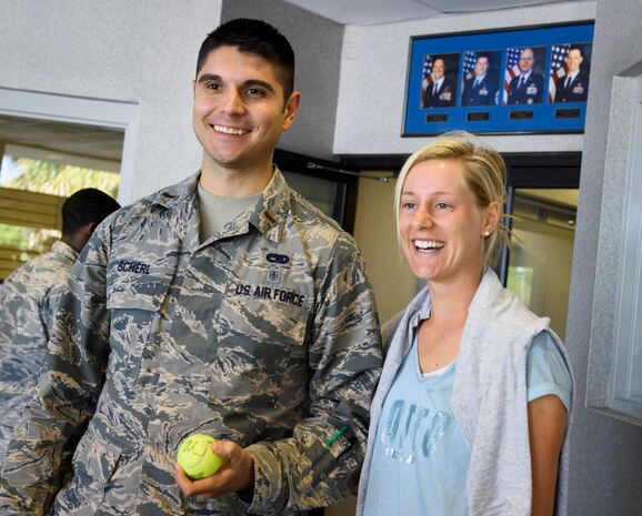 2nd Lt. Richard Scherl, 437th Aircraft Maintenance Squadron, receives an autographed tennis ball from Alison Riske, professional tennis player, April 5, 2016, at the fitness center on Joint Base Charleston – Air Base, S.C. Riske is in Charleston competing in the Family Circle Cup tennis tournament and visited the Air Base to sign autographs for Team Charleston members and tour a C-17 Globemaster III. (U.S. Air Force photo/Senior Airman Clayton Cupit)