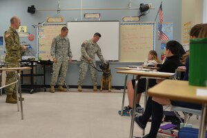 U.S. Soldiers with Fort Eustis’ 3rd Military Police Detachment demonstrate and talk about what it takes to be a military working-dog handler at Booker T. Washington Middle School in Newport News, Va., April 1, 2016. Soldiers from various U.S. Army careers visited the school to give the students a broad understanding of careers available to them within the Army. (U.S. Air Force photo by Staff Sgt. Natasha Stannard)