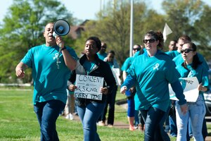Community members from Joint Base Langley-Eustis march to Memorial Park during a Sexual Assault Awareness Month rally at Langley Air Force Base, Va., April 4, 2016. The rally aimed to increase awareness of the observance month, which is an annual campaign to educate communities on preventing sexual. (U.S. Air Force photo by Senior Airman R. Alex Durbin) 