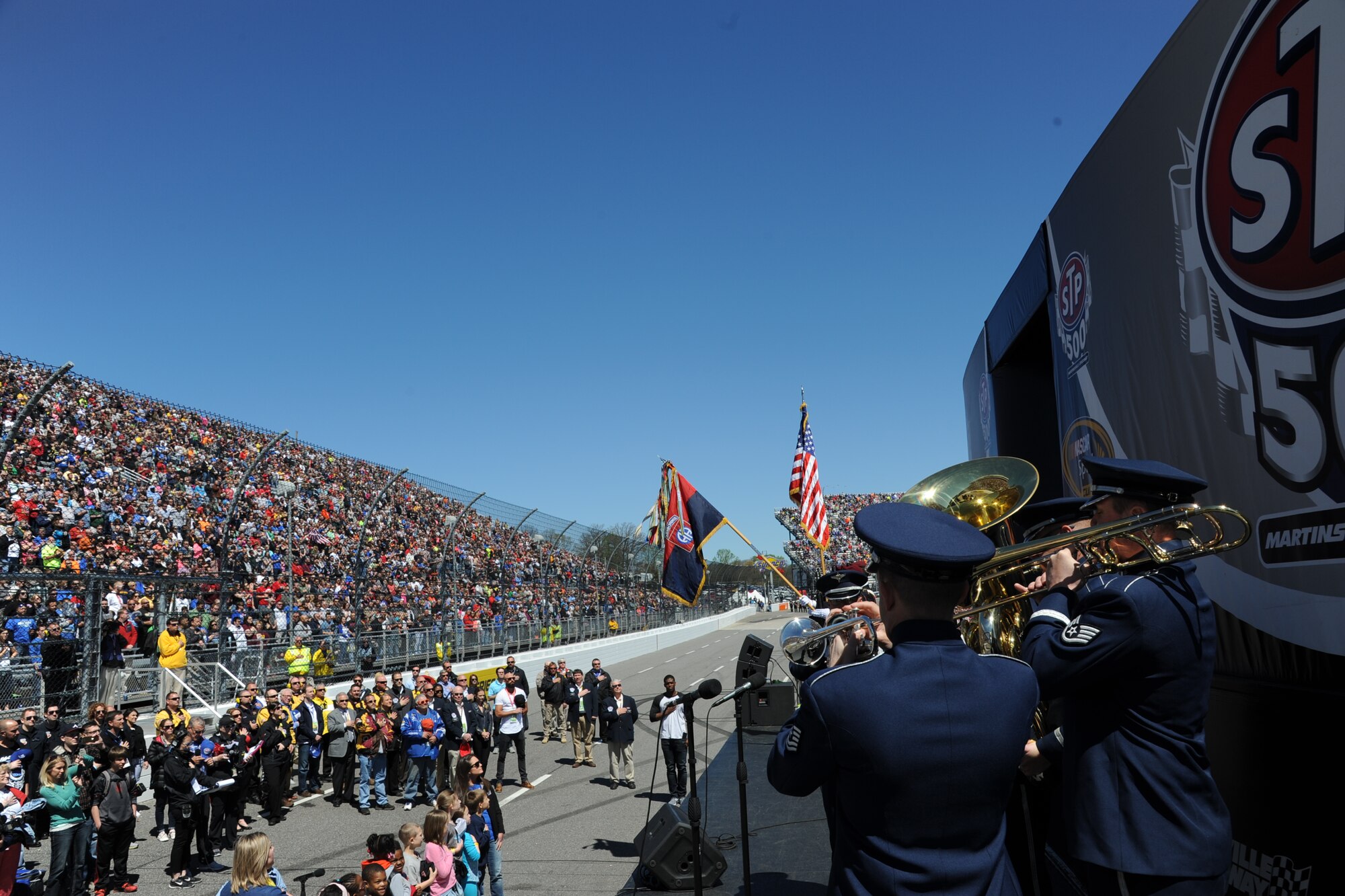U.S. Air Force Heritage of America Band, Full Spectrum and Heritage Brass perform for NASCAR fans at Martinsville, Va., April 3, 2016. The band’s performances are specifically a part of a Public Affairs Community Outreach and Recruiting mission, which also coincided with the commemoration of the 50th anniversary of the Vietnam War. (U.S. Air Force photo by Staff Sgt. William Anger/Released)

