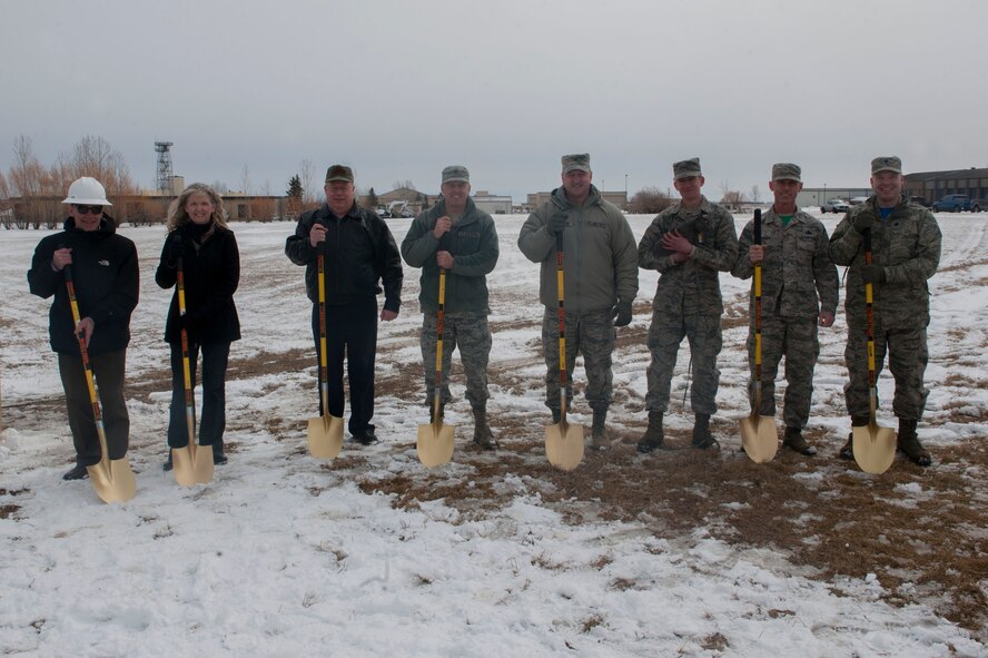 Base leadership and various contractors pose with the 5th Aircraft Maintenance Squadron mascot, Buffy, before the ground breaking ceremony at Minot Air Force Base, N.D., April 1, 2016. The 5th AMXS is currently split into separate buildings throughout the flight line, some in which were constructed in the 1950s. The new facility will provide consolidation and needed updates for the maintainers. (U.S. Air Force photo/Airman 1st Class Jessica Weissman)