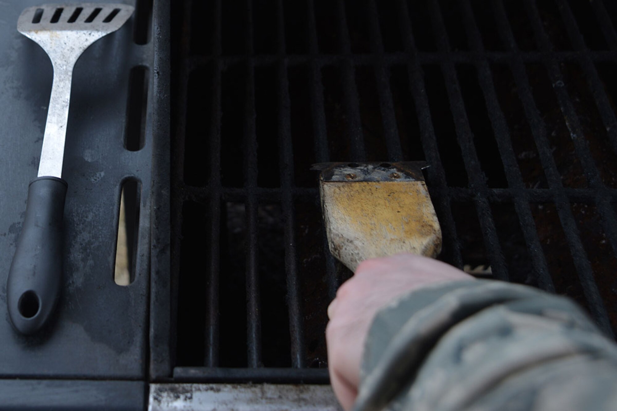 For some, grilling can be a popular summer activity. Officials of the 673d Civil Engineer Squadron Fire Department, suggest regular cleaning of grills because grease or fat buildup can be a fuel source for fires, and might attract wildlife. (U.S. Air Force photo by Airman 1st Class Javier Alvarez)