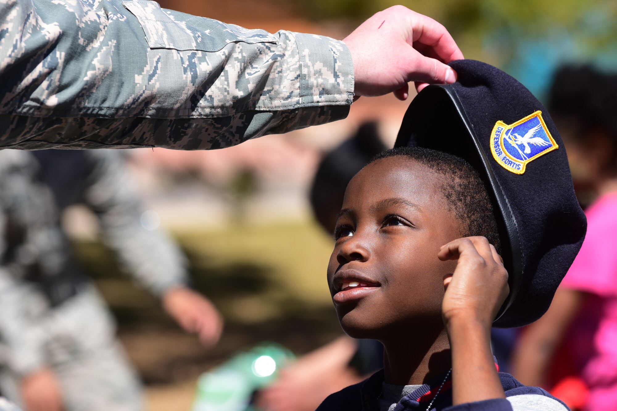PETERSON AIR FORCE BASE, Colo. - A Team Pete child tries on a Security Forces beret at the 21st Force Support Squadron’s Kids Understanding Deployment Operations event at Peterson Air Force Base, Apr. 2, 2016. K.U.D.O.S. is an event geared toward enhancing military children’s knowledge of what their parents experience pre-deployment. (U.S. Air Force photo by Staff Sgt. Amber Grimm)