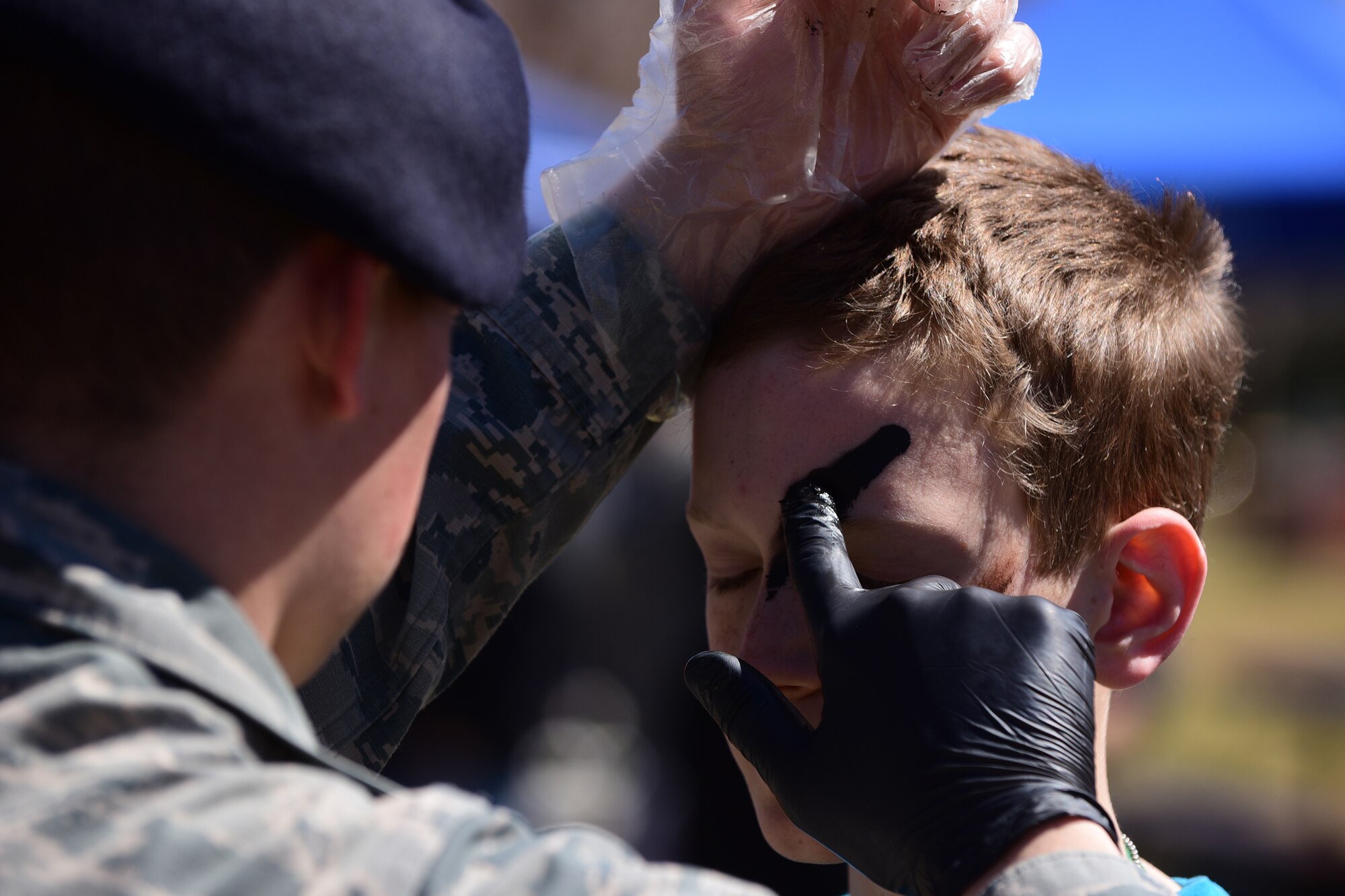 PETERSON AIR FORCE BASE, Colo. - Children of Team Pete are painted in combat camouflage patterns as part of the 21st Force Support Squadron’s Kids Understanding Deployment Operations event at Peterson Air Force Base, Apr. 2, 2016. K.U.D.O.S. was an opportunity for military children to go through their own mini deployment and learn a little of what their parents do when the have to deploy. (U.S. Air Force photo by Staff Sgt. Amber Grimm)