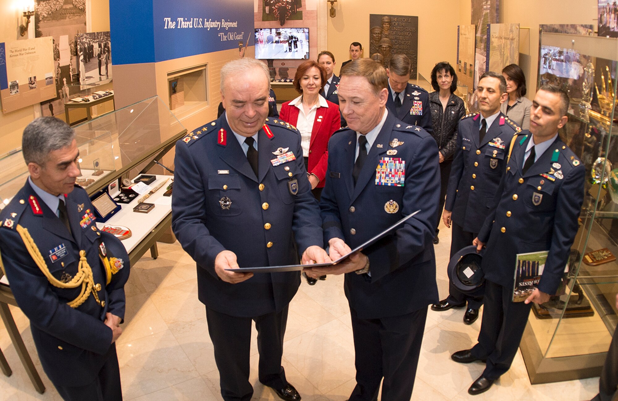 General Abidin Ünal, Turkish Air Force Chief of Staff, is presented a memento by Air Force District of Washington Commander Maj. Gen. Darryl Burke while visiting the Tomb of the Unknown Soldier for a wreath laying ceremony at Arlington National Cemetery on Apr. 4, 2016. Distinguished visitors commonly pay formal respects to the sacrifice of America's veterans in foreign wars by placing a wreath before the Tomb. The Air Force District of Washington brings air, space and cyberspace capabilities to the joint team protecting the nation's capital, and supports local personnel and those serving worldwide. (Photo/ Andy Morataya)