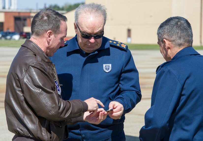 Col. Brad Hoagland (left), 11th Wing/Joint Base Andrews commander, presents an 11 WG coin to Gen. Abidin Ünal.  Ünal visited JBA to familiarize himself with the 1st Helicopter Squadron operations and strengthen relations. (U.S. Air Force photo by Senior Airman Ryan J. Sonnier/RELEASED)