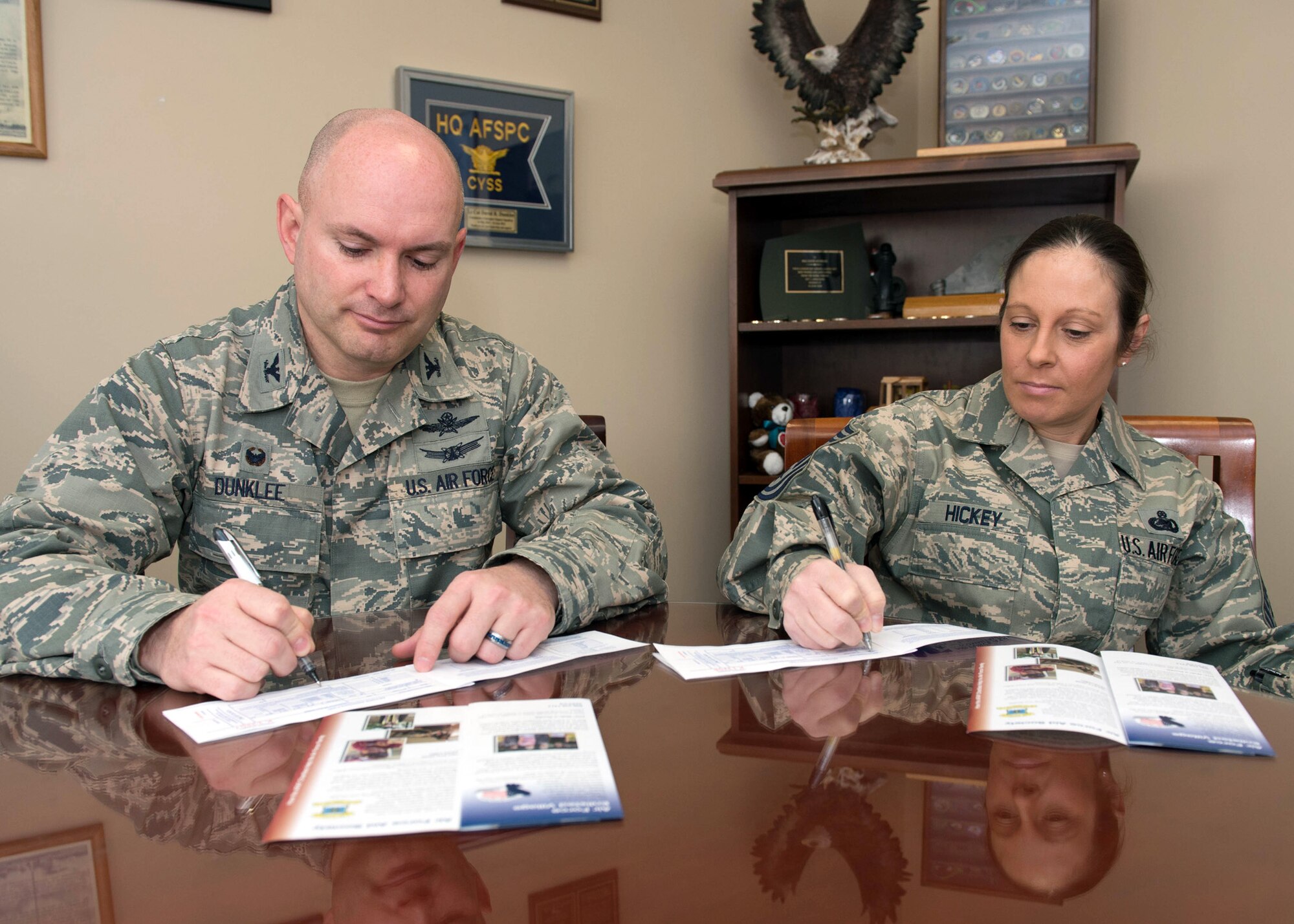 Col. David R. Dunklee, installation commander, and Command Chief Master Sgt. Patricia A. Hickey fill out their Air Force Assistance Fund contribution form in Building 1305 April 5. The 2016 Air Force Assistance Fund campaign kicked off at Hanscom March 21 and will continue through April 29. (U.S. Air Force photo by Jerry Saslav) 