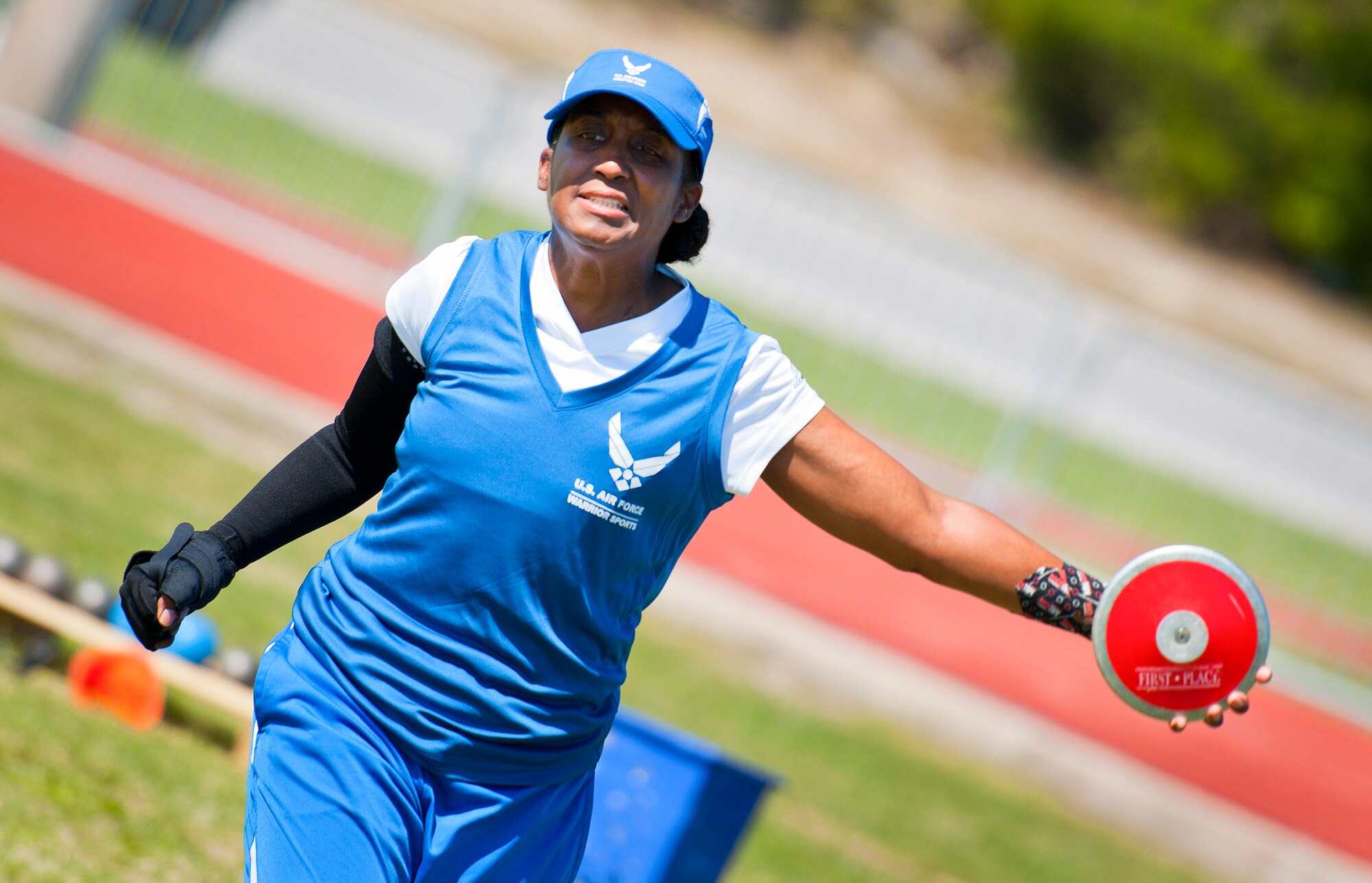 Julianna Walker, a Warrior Games athlete, releases a discus his toss during an afternoon track and field session at the Air Force team’s training camp at Eglin Air Force Base, Fla., April 5.  The base-hosted, week-long Warrior Games training camp is the last team practice session before the yearly competition in June.  (U.S. Air Force photo/Samuel King Jr.)