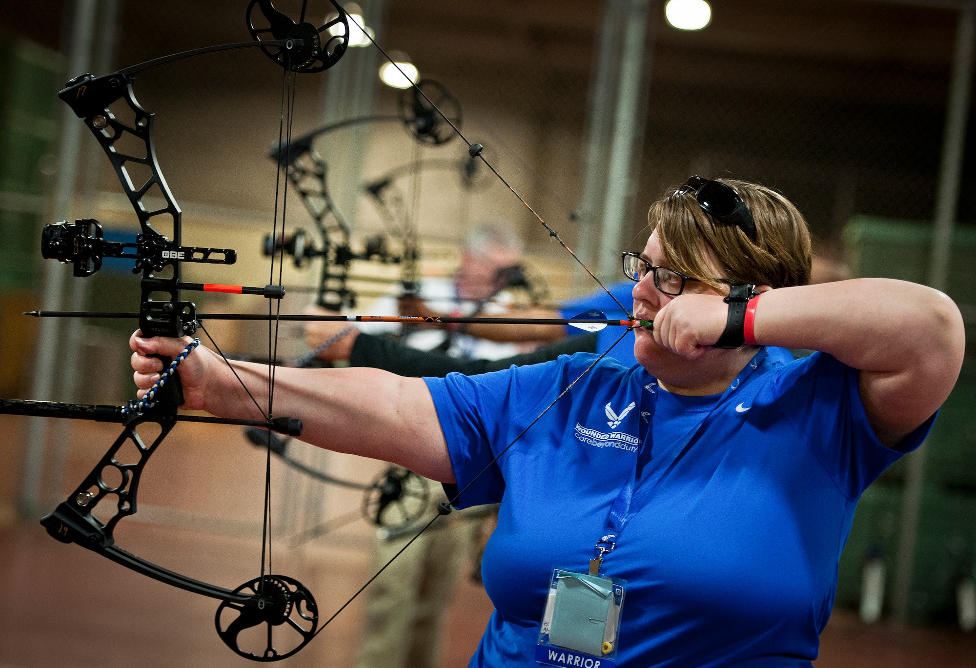 Cynthia Moss, a Warrior Care attendee, lines up her shot during a morning archery session at the Air Force team’s training camp at Eglin Air Force Base, Fla., April 5.  The base-hosted, week-long Warrior Games training camp is the last team practice session before the yearly competition in June.  (U.S. Air Force photo/Samuel King Jr.)