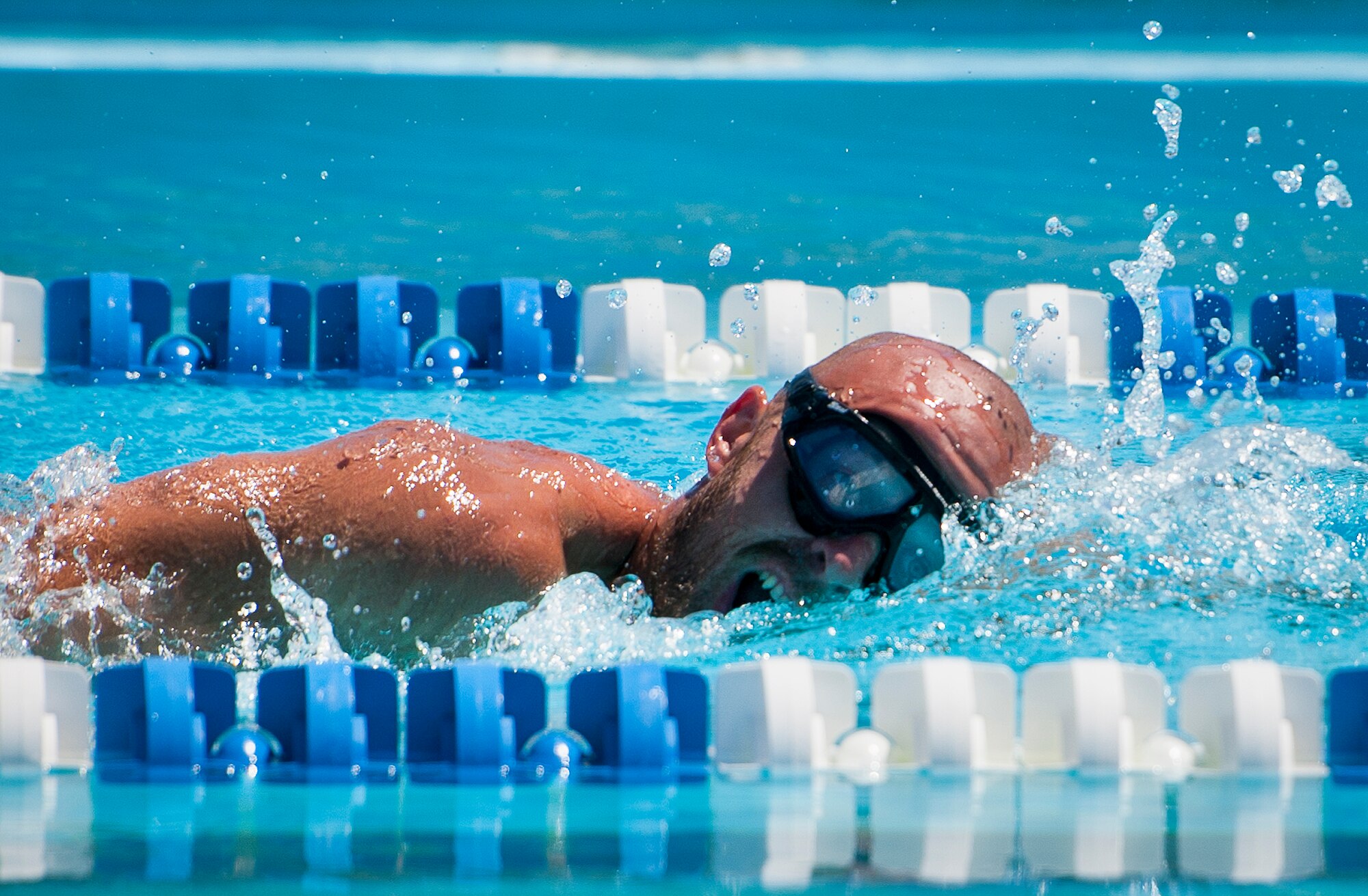 Arthur Zingler, a Warrior CARE attendee, takes in a breath of air during a morning swim session at the adaptive sports camp at Eglin Air Force Base, Fla., April 5.  The base hosts the week-long Wound Warrior Care event that helps recovering wounded, ill and injured military members through specific hand-on rehabilitative training.  (U.S. Air Force photo/Samuel King Jr.)