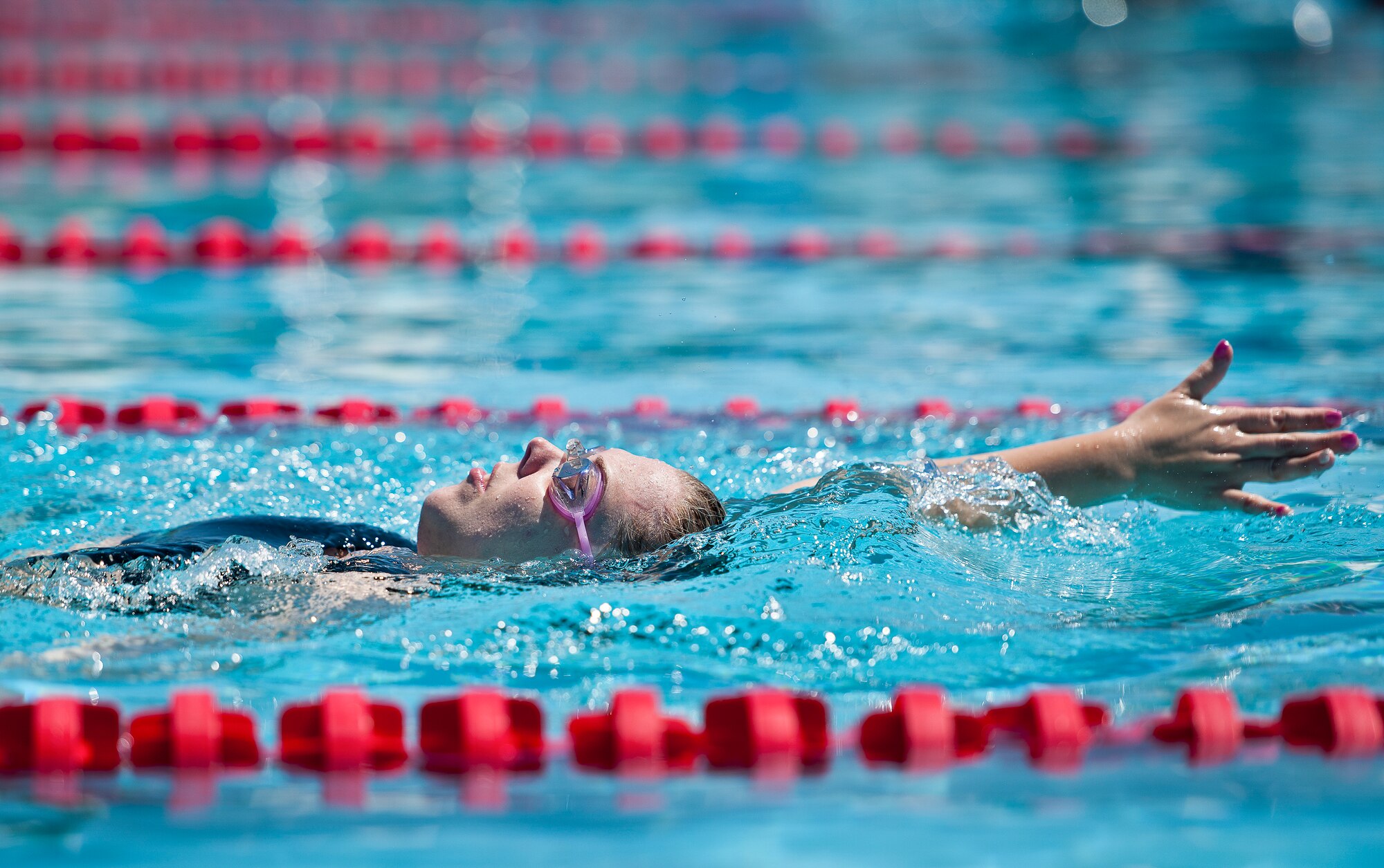 Heather Carter, a Warrior Care attendee, practices her backstroke during a morning swim session at the adaptive sports camp at Eglin Air Force Base, Fla., April 5.  The base hosts the week-long Wound Warrior Care event that helps recovering wounded, ill and injured military members through specific hand-on rehabilitative training.  (U.S. Air Force photo/Samuel King Jr.)