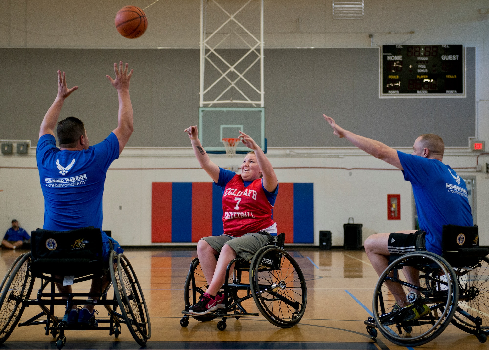 Lindie Kobel, a Warrior Care attendee, tosses a pass during a wheelchair basketball session at the adaptive sports camp at Eglin Air Force Base, Fla., April 5.  The base hosts the week-long Wound Warrior Care event that helps recovering wounded, ill and injured military members through specific hand-on rehabilitative training.  (U.S. Air Force photo/Samuel King Jr.)