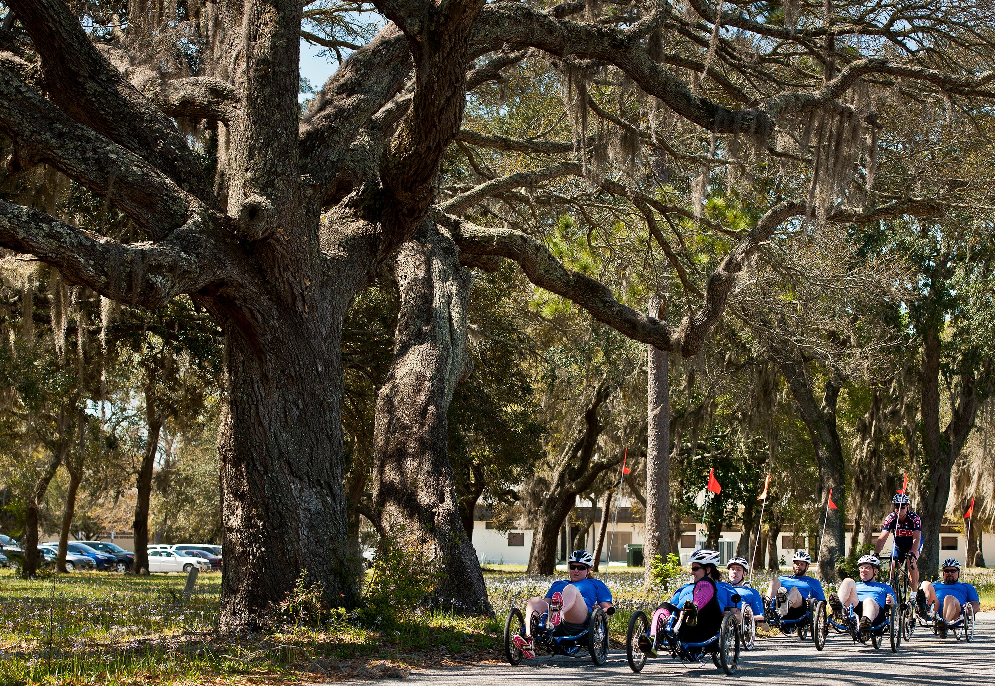 Warrior Care attendees ride on recumbent bikes along the roads behind Post’l Point during a morning cycling session at the adaptive sports camp at Eglin Air Force Base, Fla., April 5.  The base hosts the week-long Wound Warrior Care event that helps recovering wounded, ill and injured military members through specific hand-on rehabilitative training.  (U.S. Air Force photo/Samuel King Jr.)