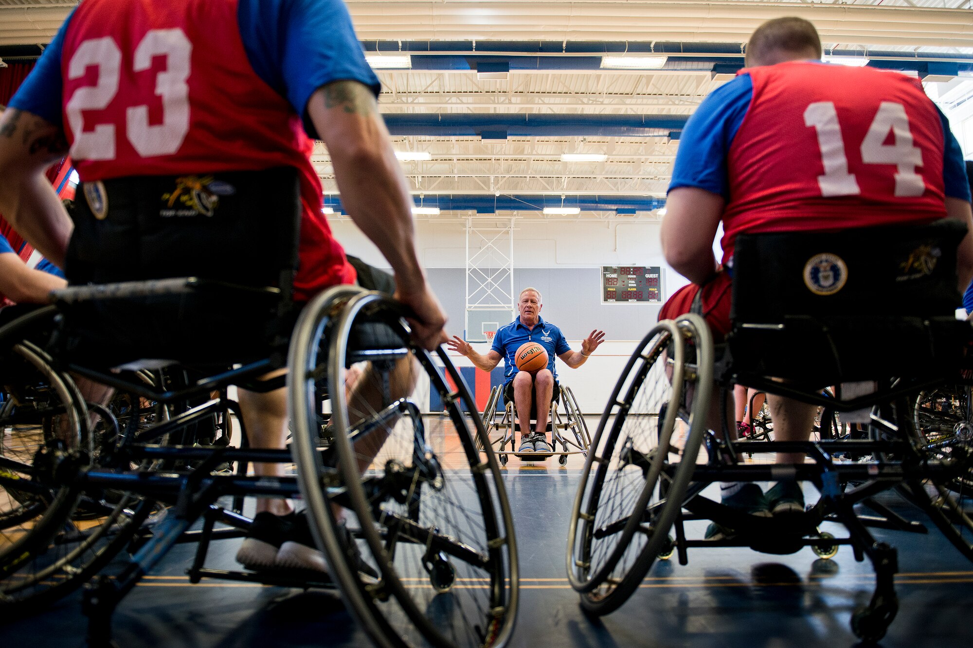 Mark Shepherd, an Air Force Wounded Warrior coach, talks to attendees during a wheelchair basketball session at the adaptive sports camp at Eglin Air Force Base, Fla., April 5.  The base hosts the week-long Wound Warrior Care event that helps recovering wounded, ill and injured military members through specific hand-on rehabilitative training.  (U.S. Air Force photo/Samuel King Jr.)