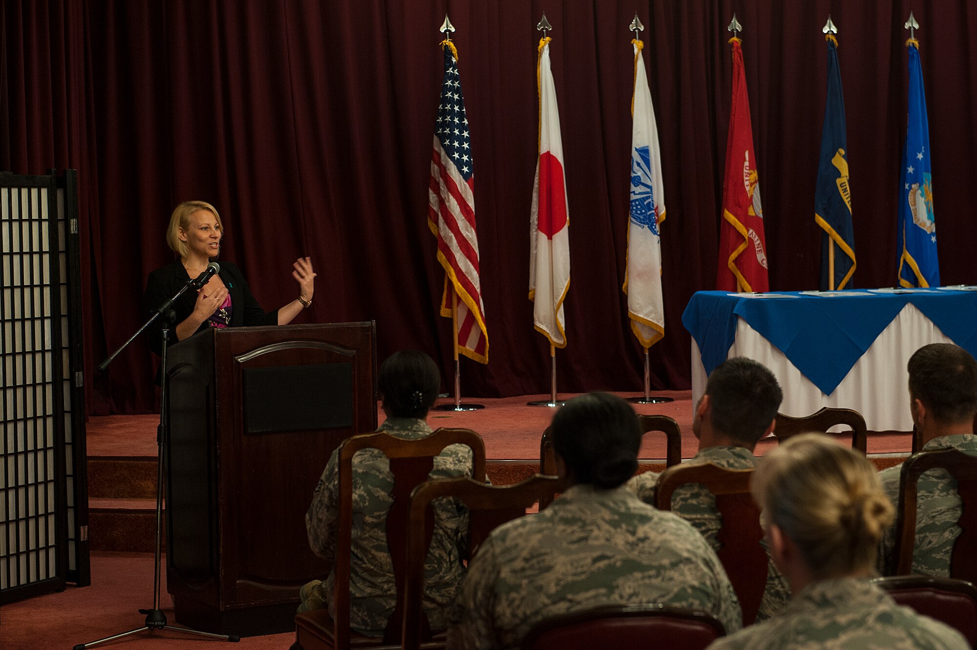 Laurie Scudder, Sexual Assault Prevention and Response specialist, speaks to a crowd during a ceremony held for military leaders from around Okinawa to sign a proclamation making April Sexual Assault Awareness and Prevention Month April 4, 2016, at Kadena Air Base, Japan. Scudder talked about her experience as a SAPR specialist and why it is important to keep up the fight to prevent sexual assault. (U.S. Air Force photo by Airman 1st Class Corey M. Pettis)
