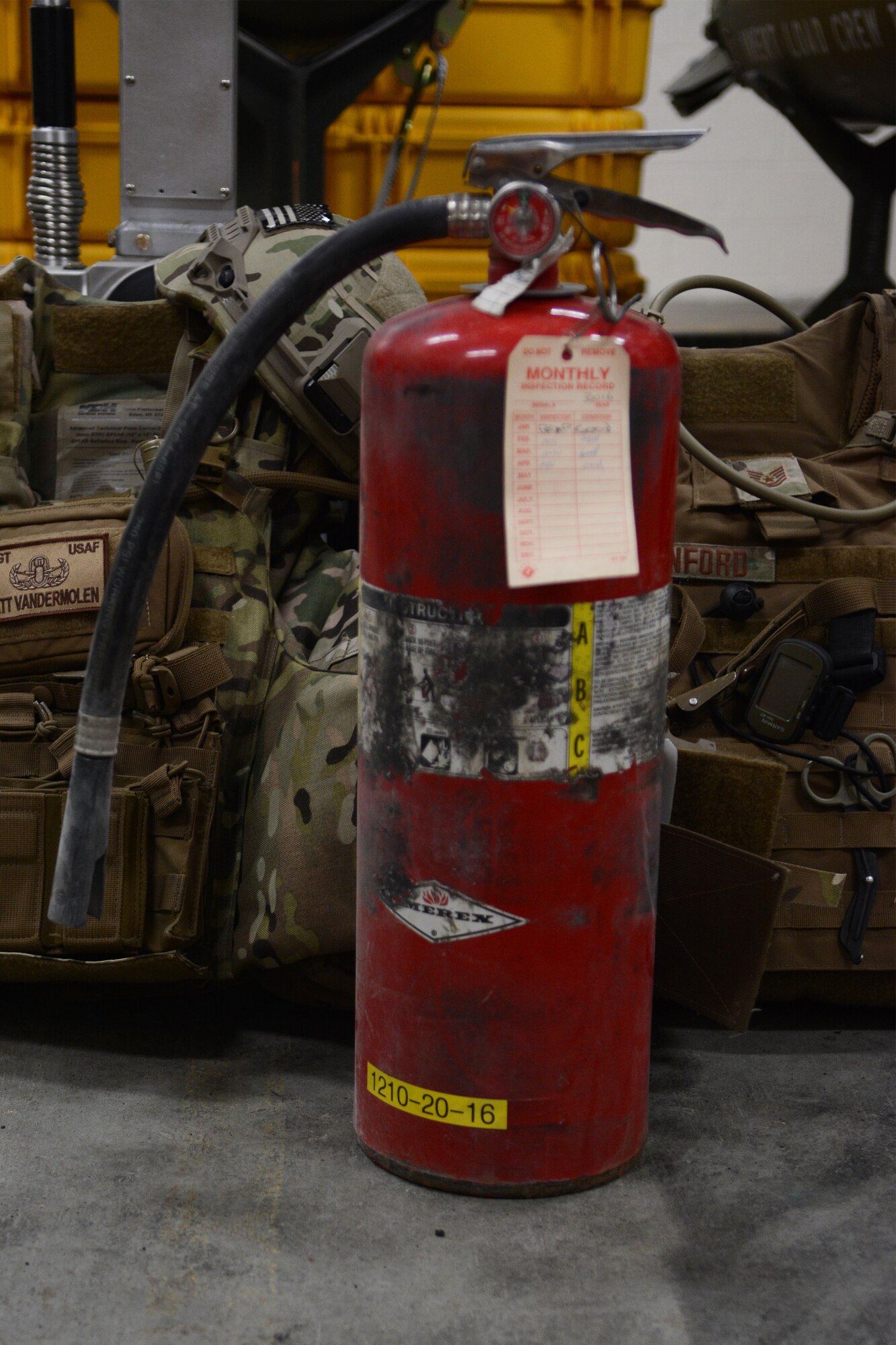 A fire extinguisher sits on the ground of an Explosive Ordnance Disposal storage space at the 115th Fighter Wing in Madison, Wis., April 6, 2016. The fire extinguisher was used by an EOD Airman to put out a car fire after coming across the one-car accident on the highway. (U.S. Air National Guard photo by Staff Sgt. Andrea F. Rhode)