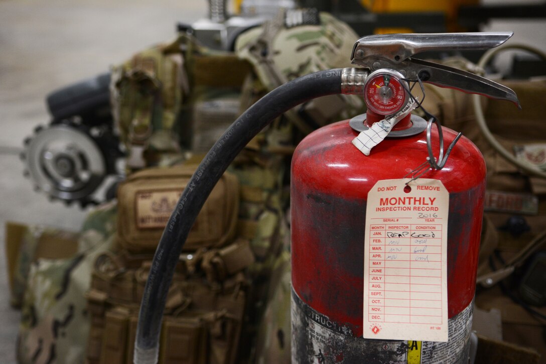 A fire extinguisher sits on the ground of an Explosive Ordnance Disposal storage space at the 115th Fighter Wing in Madison, Wis., April 6, 2016. The fire extinguisher was used by an EOD Airman to put out a car fire after coming across the one-car accident on the highway. (U.S. Air National Guard photo by Staff Sgt. Andrea F. Rhode)