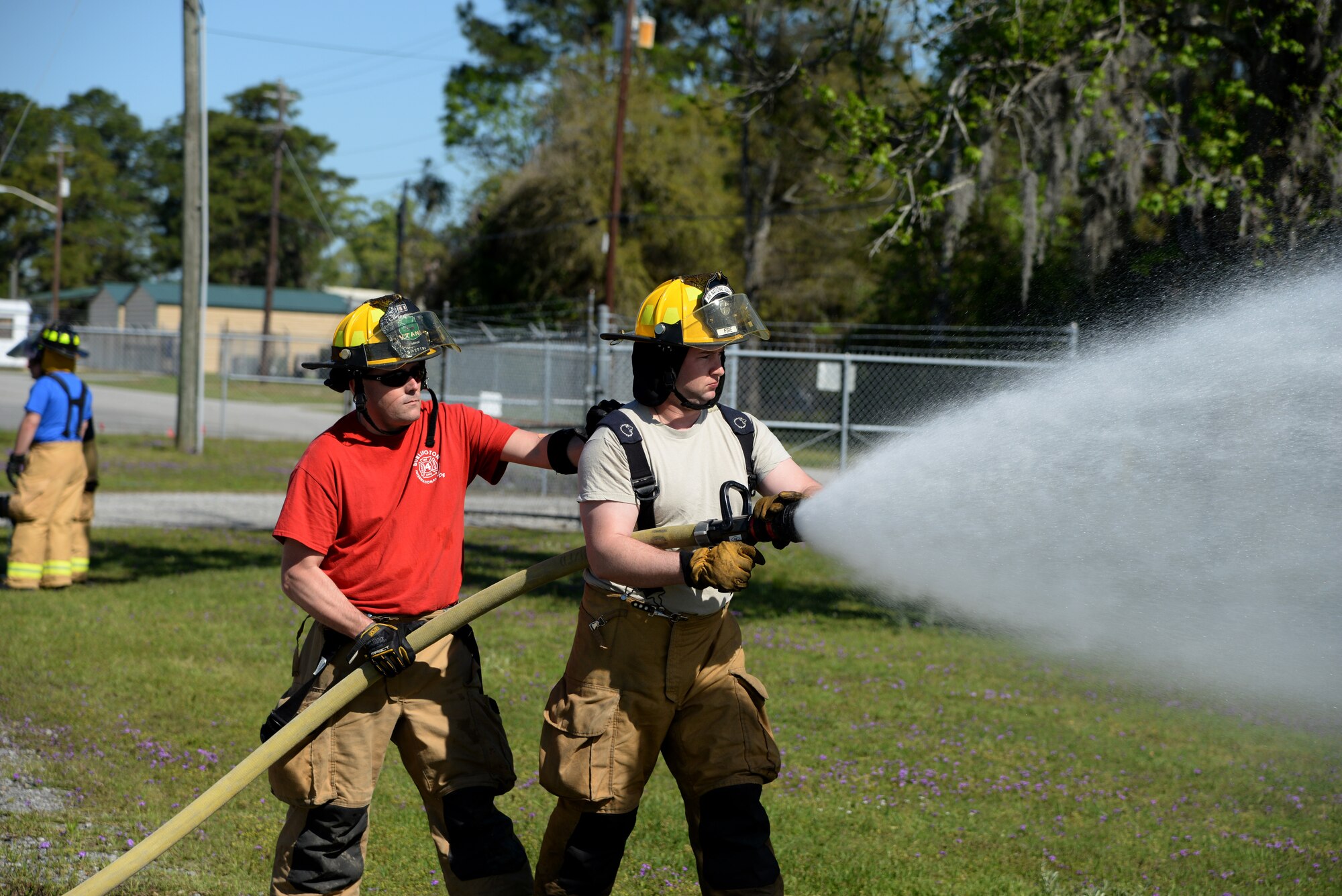 A picture of Airman 1st Class Joseph Frederickson (right) of the 143rd Airlift Wing, Rhode Island Air National Guard, and Staff Sgt. Paul Botting of the 158th Fighter Wing, Vermont Air National Guard conducting hose operation training.
