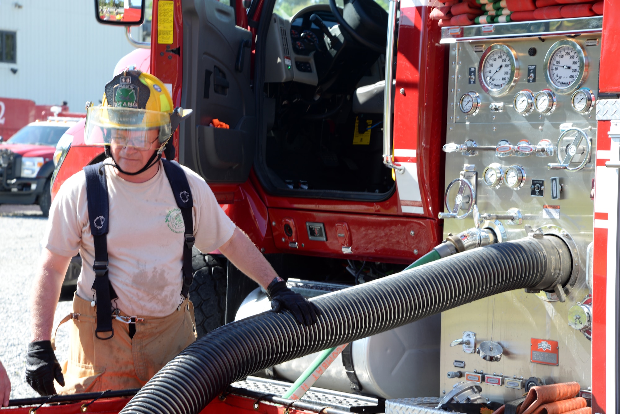 A picture of Tech. Sgt. Ben Sudduth from the 158th Fighter Wing, Vermont Air National Guard, providing instruction to airmen prior to a live aircraft fire training exercise.