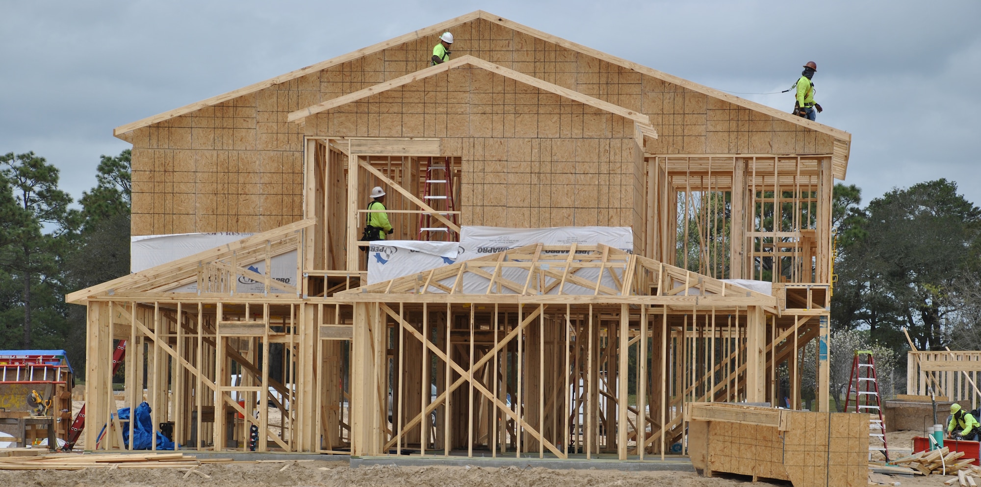 Contractors work on the framing of a new house at Eglin Air Force Base, Florida. The home is part of a new privatized base housing neighborhood opening at the base that includes a 12,000-square-foot community center.  (U.S. Air Force photo/Carole Chiles Fuller/Released)