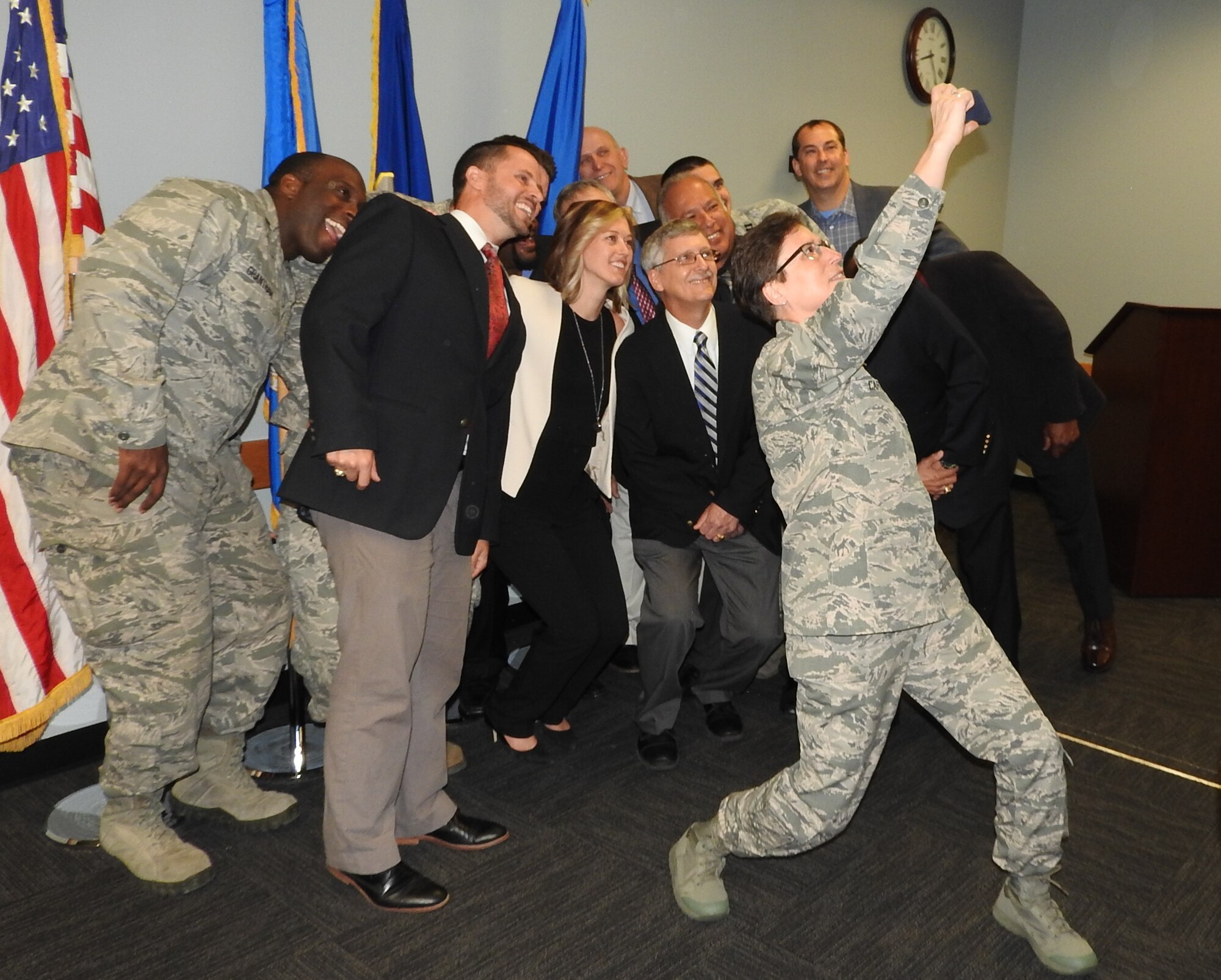 After announcing AFCEC's Activity Integration Team recently received honors as the second runner-up for the 2014 Chief of Staff Team Excellence Award, Maj. Gen. Theresa Carter, Air Force Installation and Mission Support Center commander, poses for a selfie with the team April 1, 2016. (U.S. Air Force photo/Steve Warns/Released)