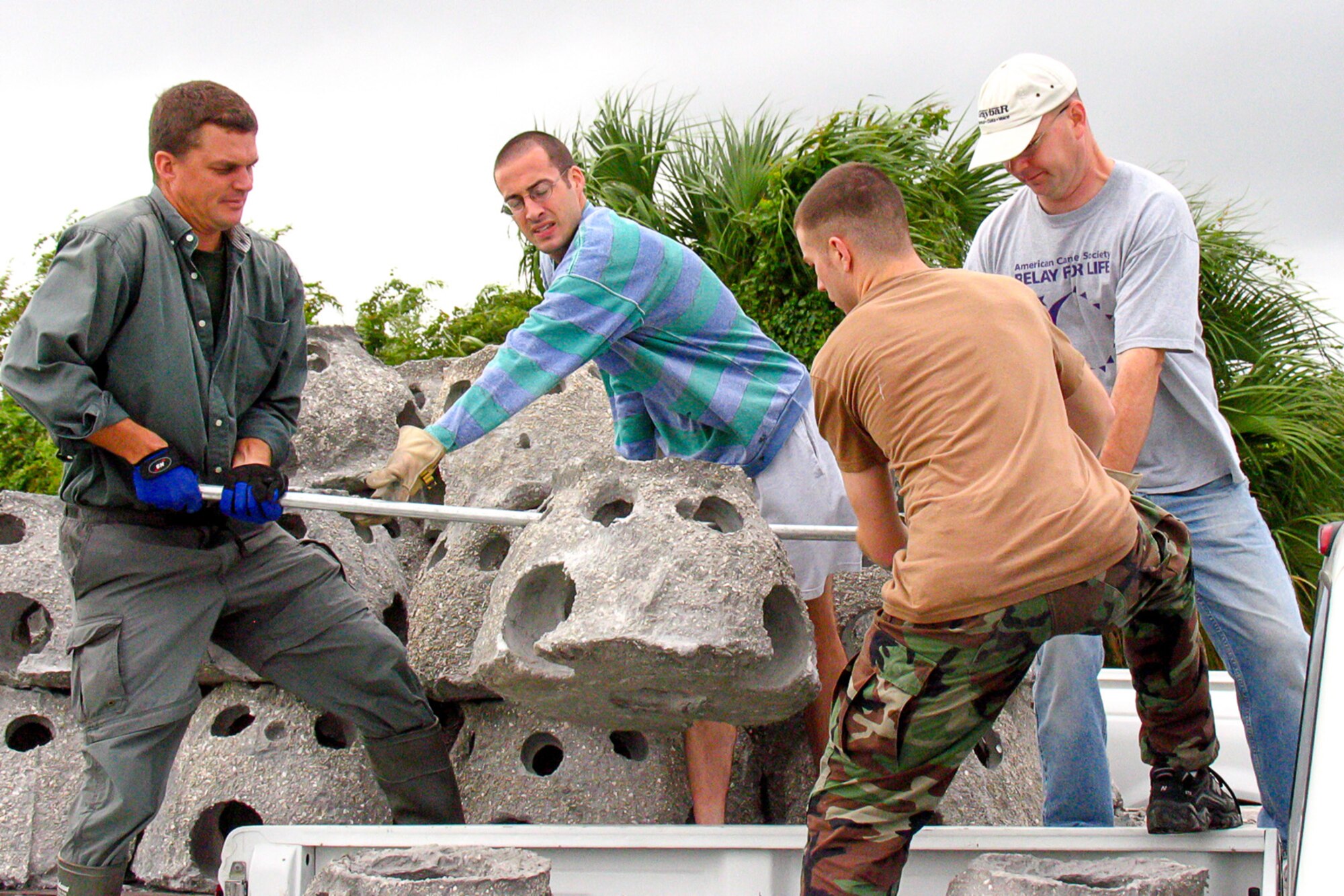 Volunteers unload marine-friendly concrete oyster domes prior to being placed in the near-shore water along the MacDill Air Force Base, Florida, southeastern shoreline as part of a long-running shoreline stabilization and restoration effort.  The Air Force Civil Engineer Center’s East Region Integrated Natural Resources Management Plan, or INRMP, team facilitated negotiations with regulators and advocated for funding on the multi-year project. The team received an environmental quality team award as part of the annual Thomas D. White Environmental Awards. (Courtesy Photo)