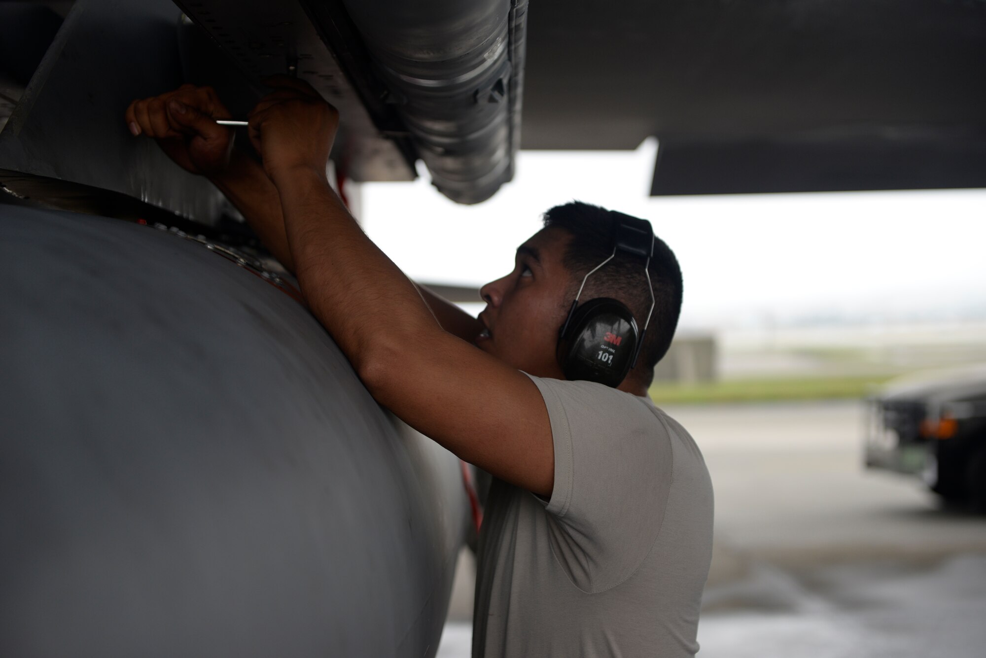 U.S. Air Force Airman Staff Sgt. Jairek Kaha’i, 18th Aircraft Maintenance Squadron weapons load crew member, tightens a bolt in preparation for loading a missile onto the aircraft during a weapons load competition April 5, 2016, at Kadena Air Base, Japan. The weapons load competition is a tradition held to raise morale and give Airmen motivation to outperform their peers. (U.S. Air Force photo by Senior Airmen Stephen G. Eigel)