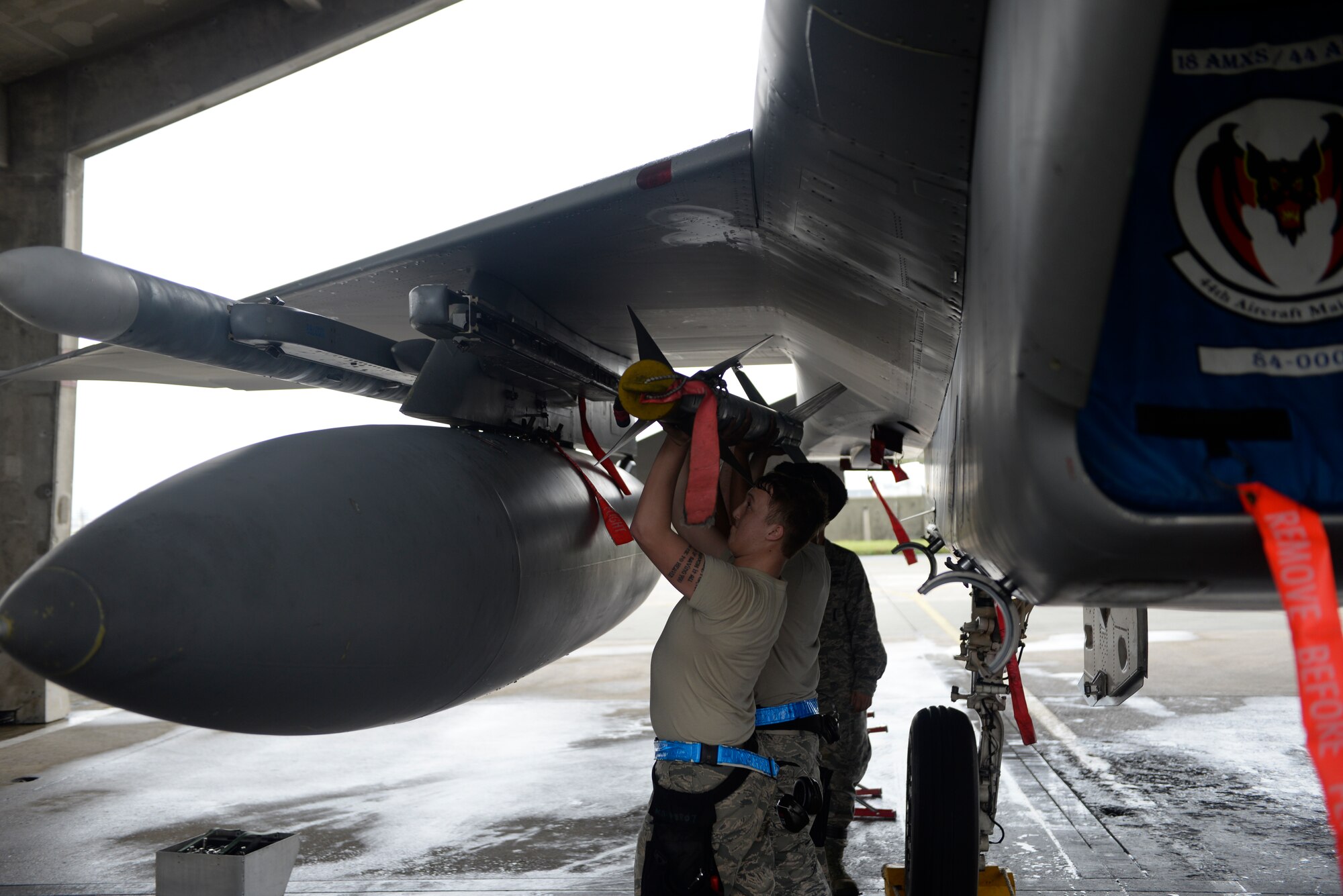 U.S. Air Force 18th Aircraft Maintenance Squadron weapons load crew members, load an AIM-9X missile during a weapons load competition April 5, 2016, at Kadena Air Base, Japan. The AIM-9X is an air-to-air, heat-seeking missile used by U.S. Air Force fighter aircraft. (U.S. Air Force photo by Senior Airman Stephen G. Eigel)