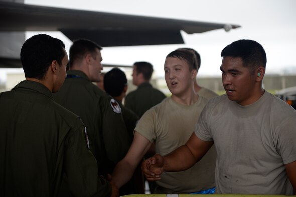 18th Aircraft Maintenance Squadron weapons load crew members are congratulated by pilots of the 44th Fighter Squadron after completing a weapons load competition April 5, 2016, at Kadena Air Base, Japan. The weapons load competition is a quarterly competition which provides a friendly competition for Airmen to compete against one another and show their skills. (U.S. Air Force photo by Senior Airman Stephen G. Eigel)