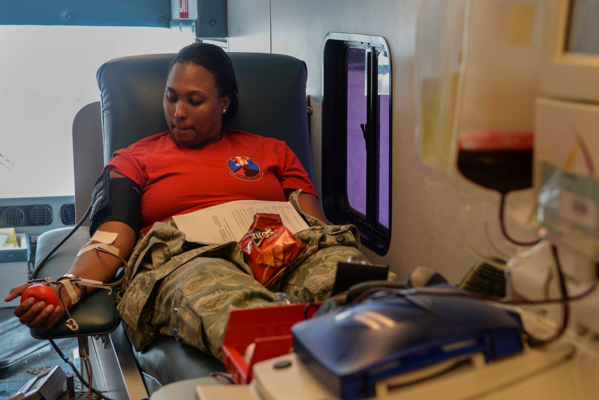Staff Sgt. Candice Thorpe, a unit deployment manager assigned to the 23rd Bomb Squadron, donates double red blood cells during a blood drive at Minot Air Force Base, N.D., March 18, 2016. Double red cell donation is similar to a whole blood donation, except a special machine is used to allow you to safely donate two units of red blood cells during one donation while returning your plasma and platelets to you. (U.S. Air Force photo/Airman 1st Class Jessica Weissman)