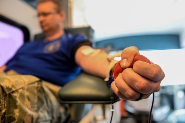 Tech. Sgt. Daniel Hubbard, an aircraft metal technology craftsman assigned to the 5th Maintenance Squadron, squeezes a stress ball while donating blood at Minot Air Force Base, N.D., March 18, 2016. Hubbard said he donates as often as he can throughout the year, which for him averages out to be four or five times. (U.S. Air Force photo/Airman 1st Class Jessica Weissman)